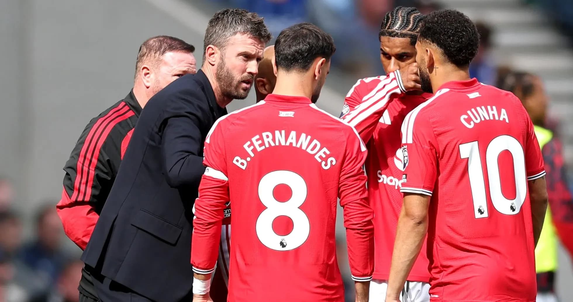 Manchester United players discussing with coach during match