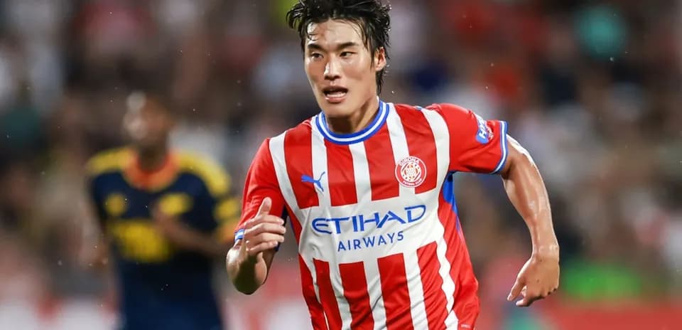 Player sprinting in red and white striped jersey