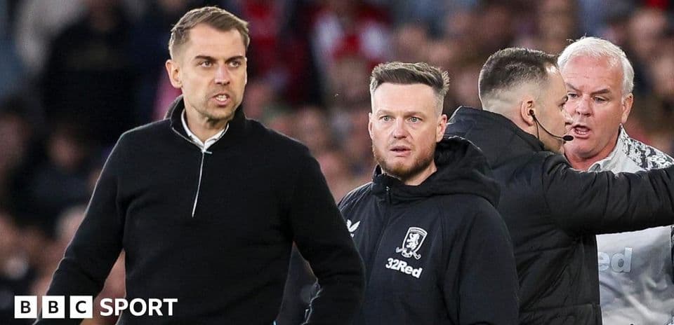 Coaches interacting on the sideline during match