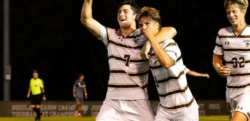 Players celebrating a goal during soccer match