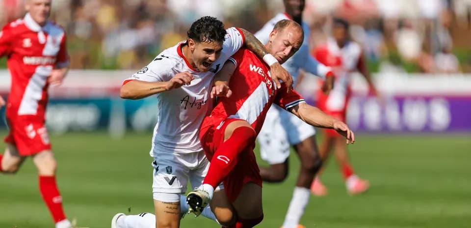 Cavalry FC player tackling Vancouver FC opponent