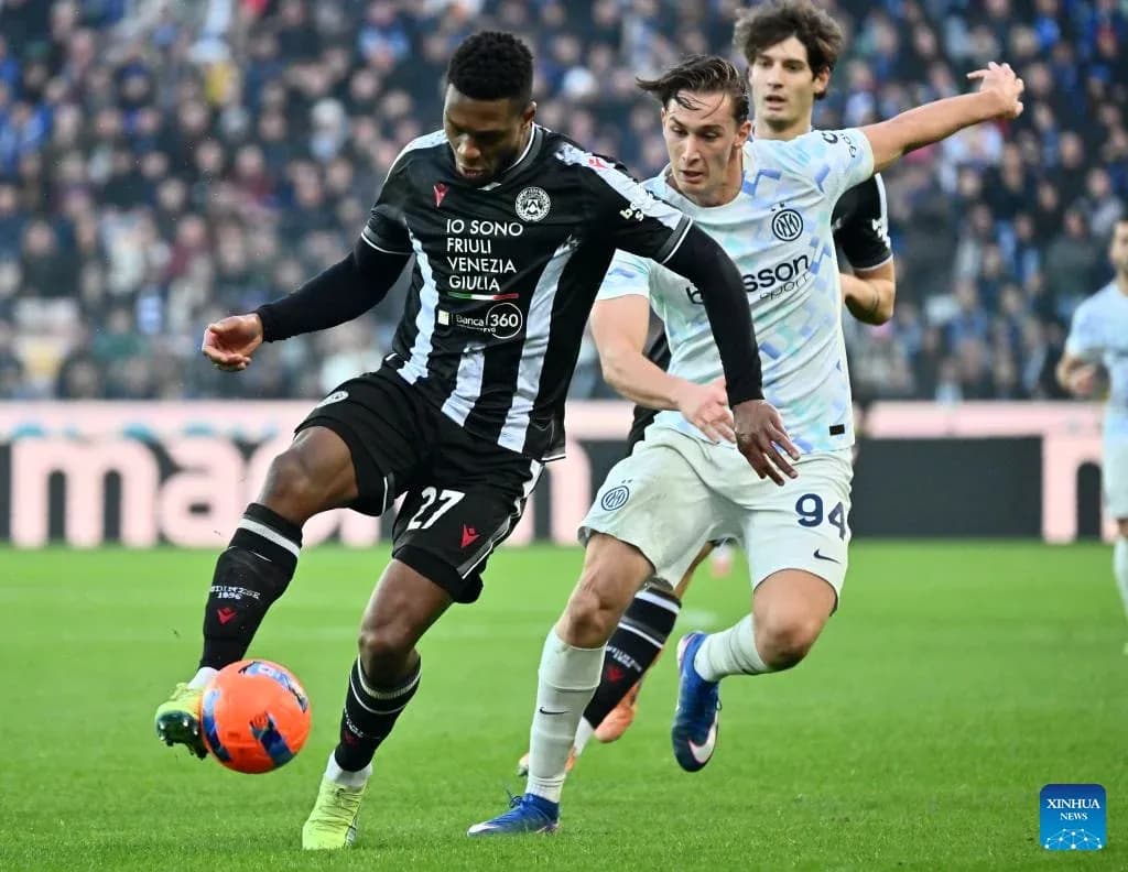 Inter player challenging Udinese player for the ball
