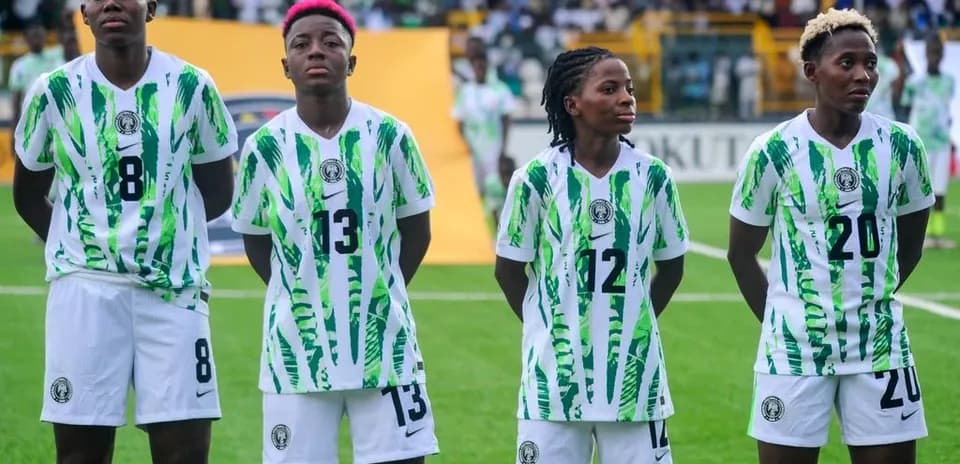 Four players in Nigeria jerseys standing in formation