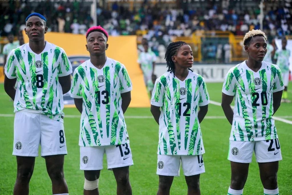 Four players in Nigeria jerseys standing in formation