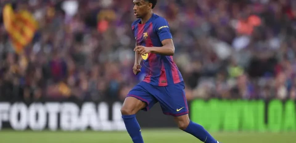Barcelona player dribbling the ball on pitch