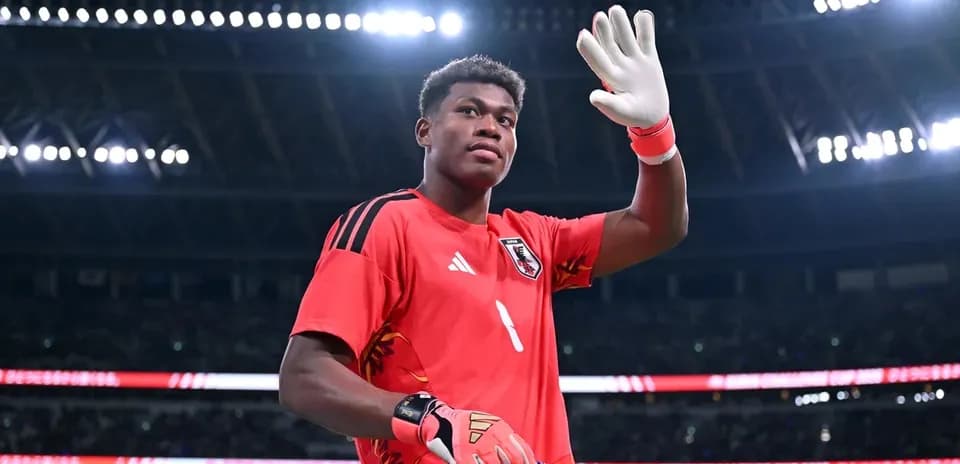 Goalkeeper waving while holding team banner
