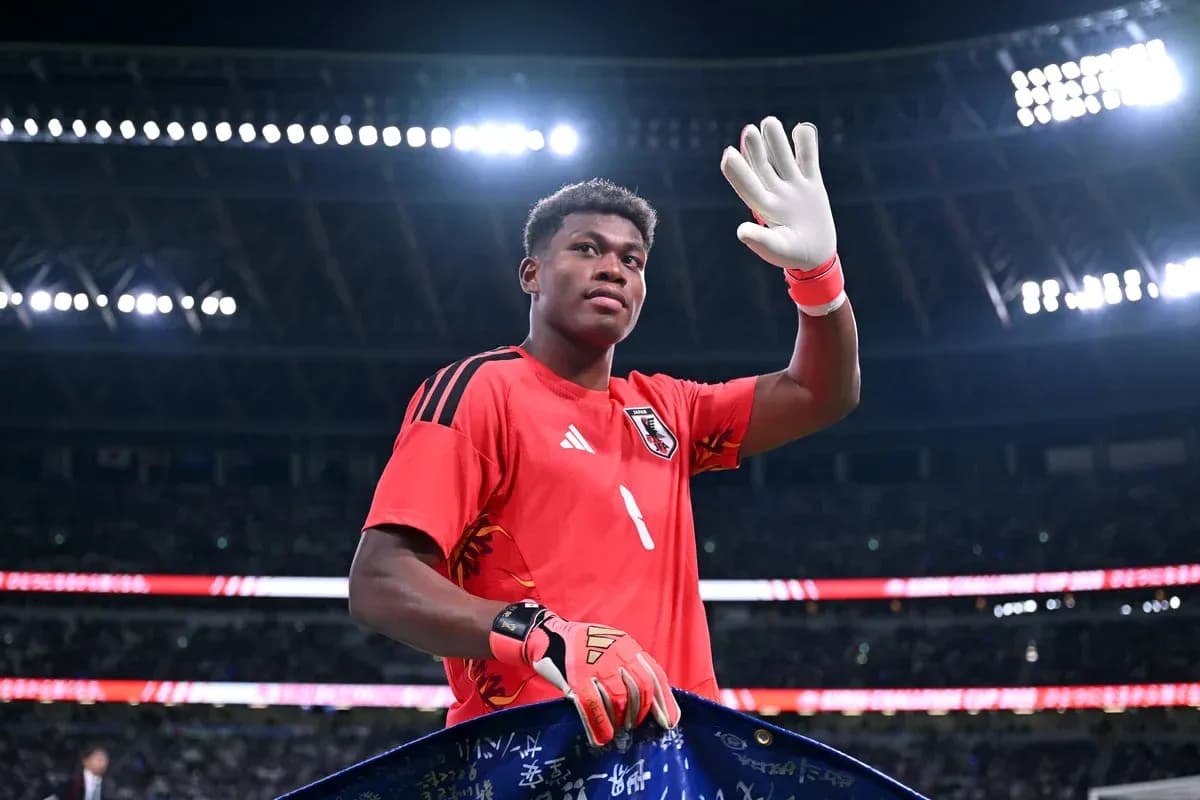 Goalkeeper waving while holding team banner