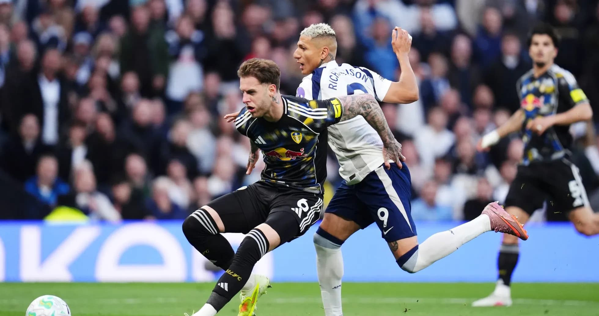 Leeds player challenged by Tottenham forward