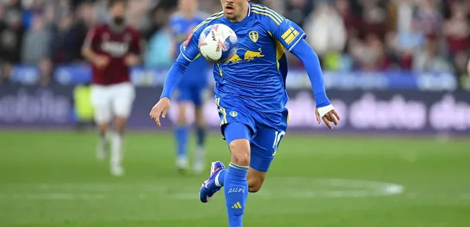 Player in blue kit dribbling the ball during match