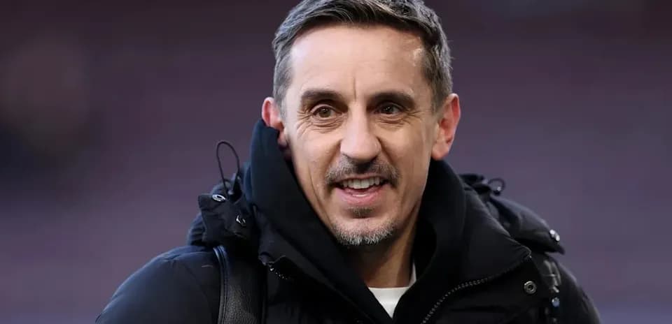 Man smiling in a black jacket outdoors