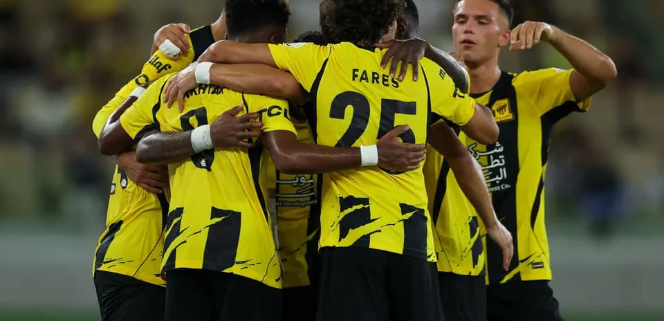 Players celebrating a goal in team huddle