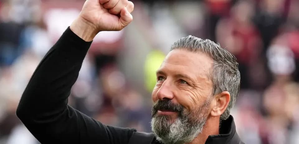 Coach celebrating with raised fist in stadium