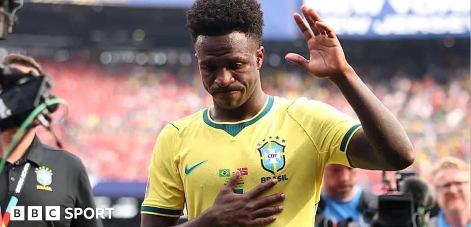 Player in Brazil kit waving during post-match