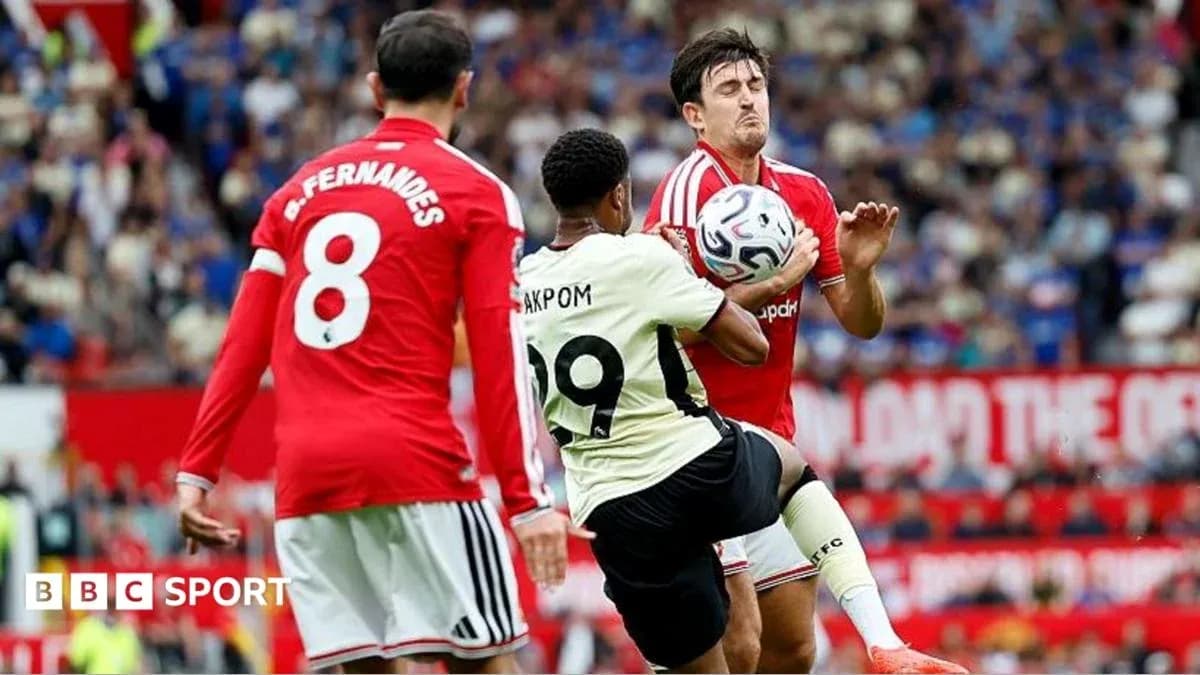Player kicking ball while two defenders approach