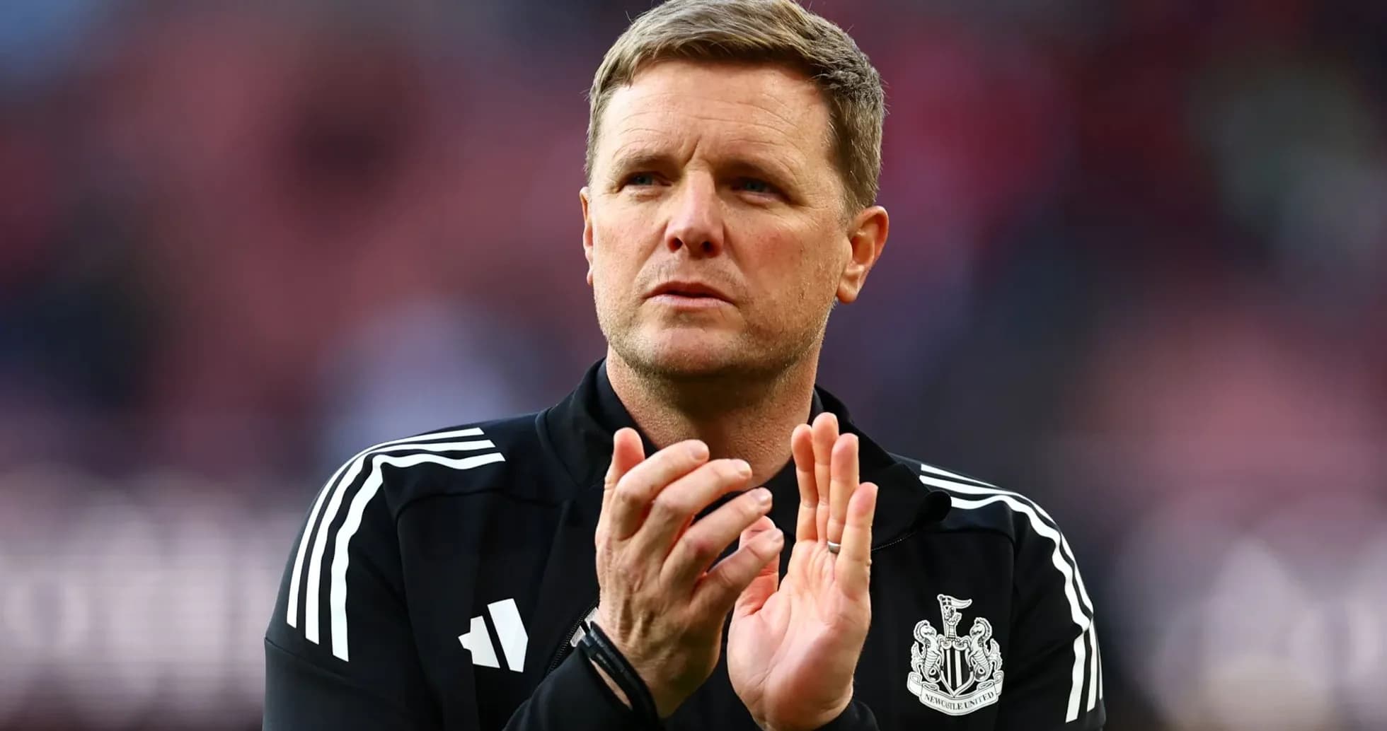Manager clapping during a match at the stadium
