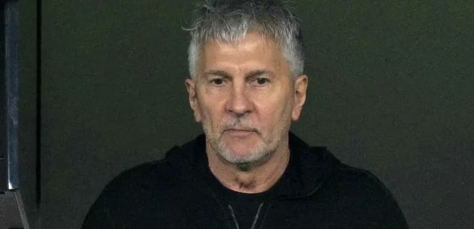 Man with gray hair wearing black hoodie
