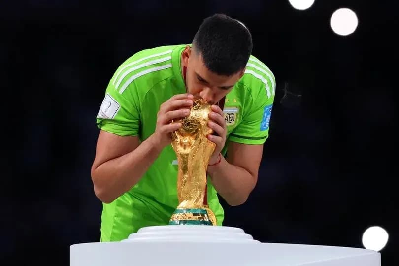 Goalkeeper kissing the FIFA World Cup trophy
