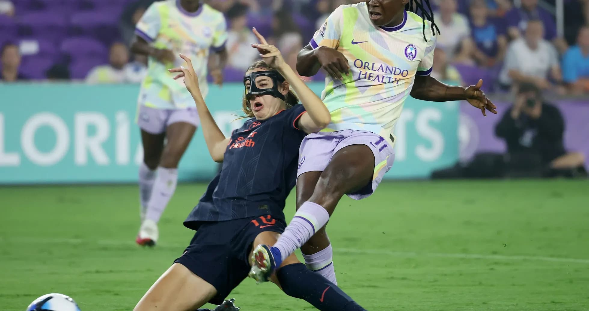 Player tackling opponent during NWSL match