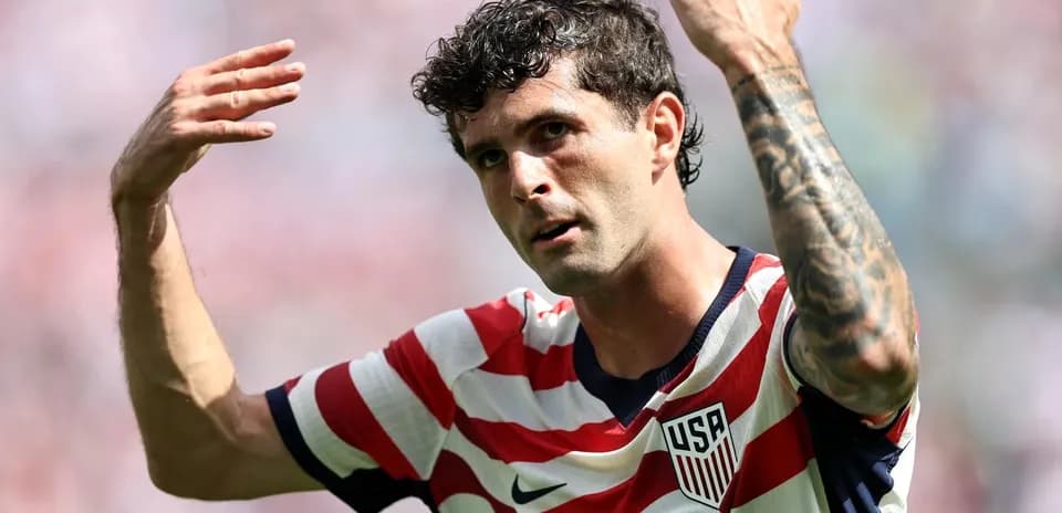 Player gesturing during match, wearing USA jersey