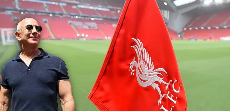 Man beside Liverpool FC corner flag at stadium