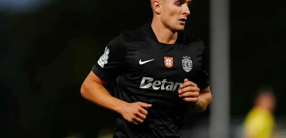 Player in black jersey running on field