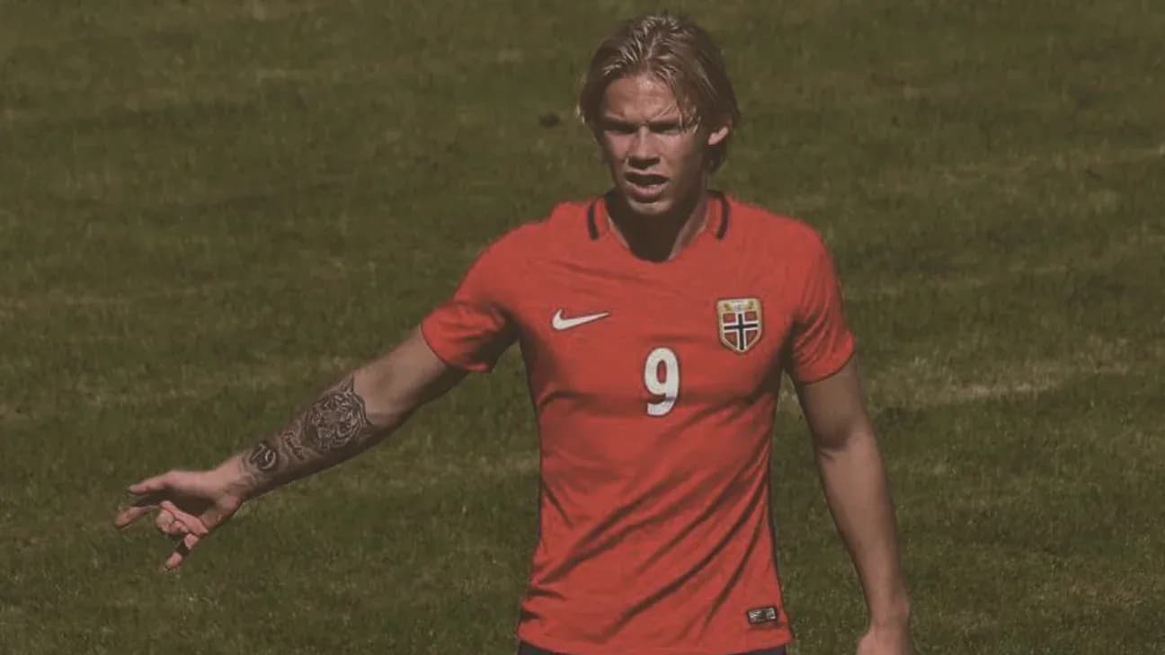 Player in red Norway jersey gesturing on field