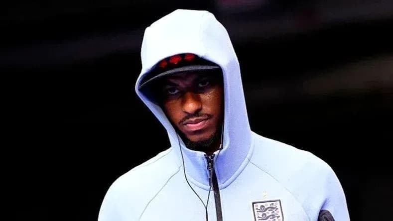 Player wearing hooded sweatshirt entering venue