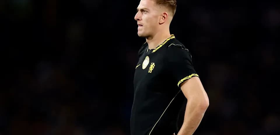 Player in black kit standing on the pitch