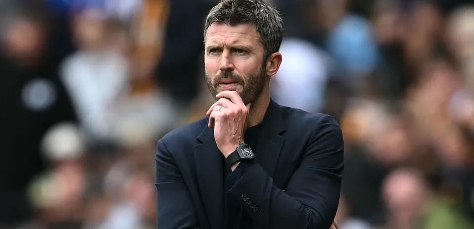 Coach observing the match with a thoughtful expression