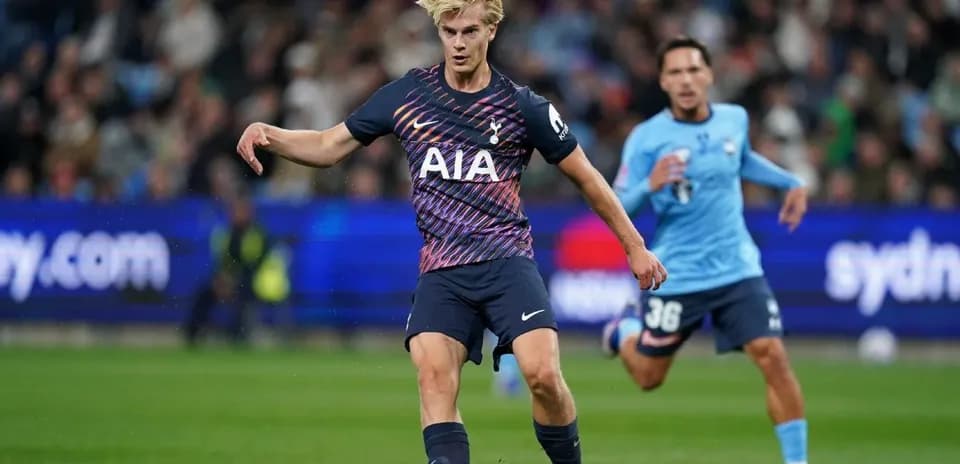 Player in Tottenham kit passing ball during match