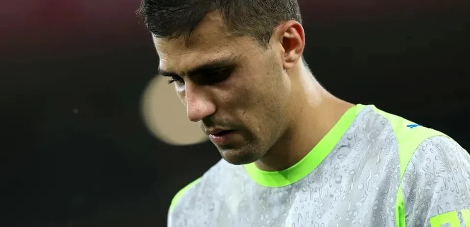 Goalkeeper in training kit looking down
