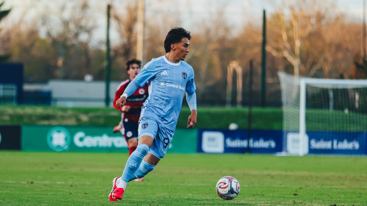 Player in blue uniform running with ball