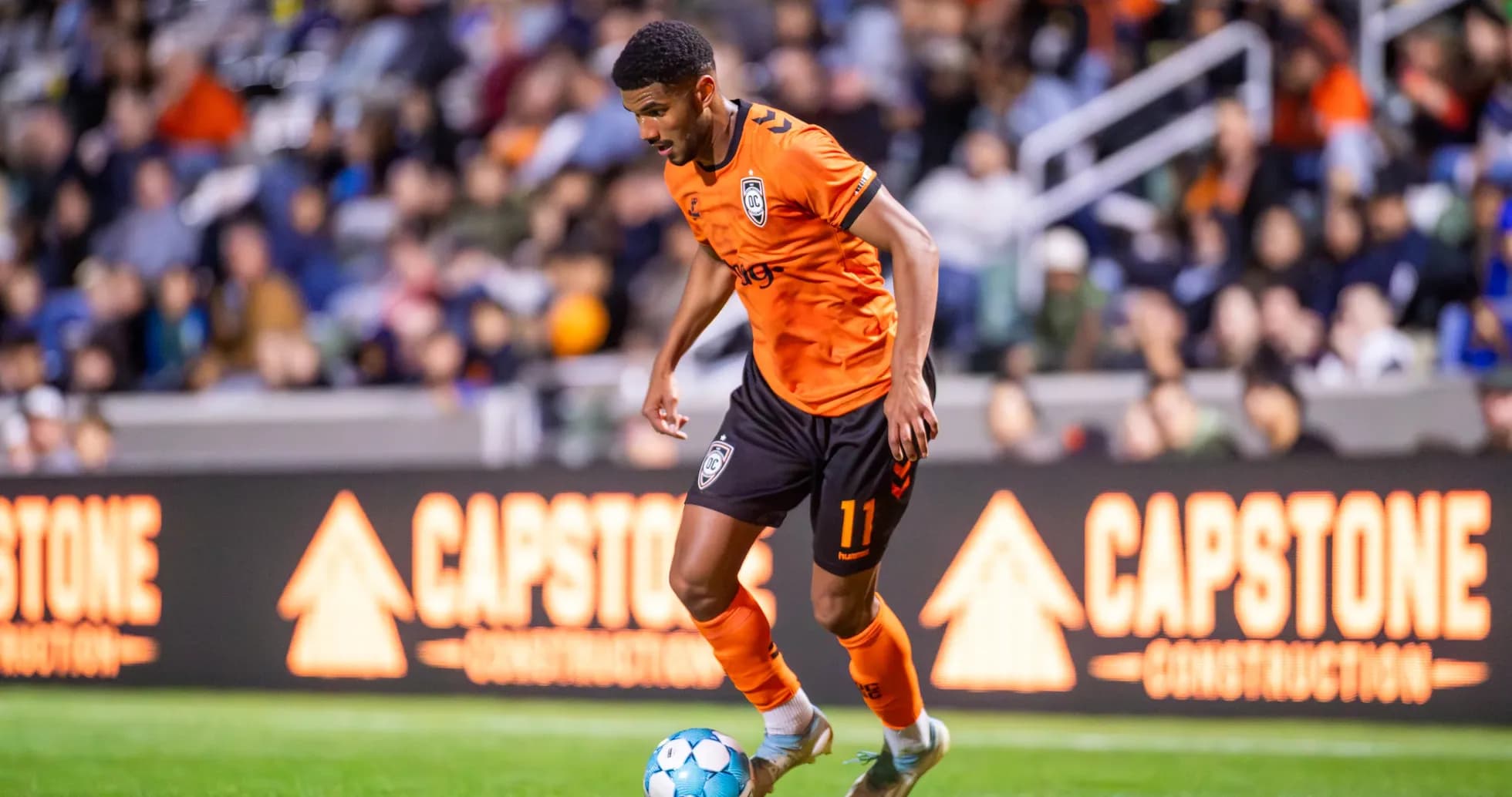 Player dribbling the ball during USL Championship match