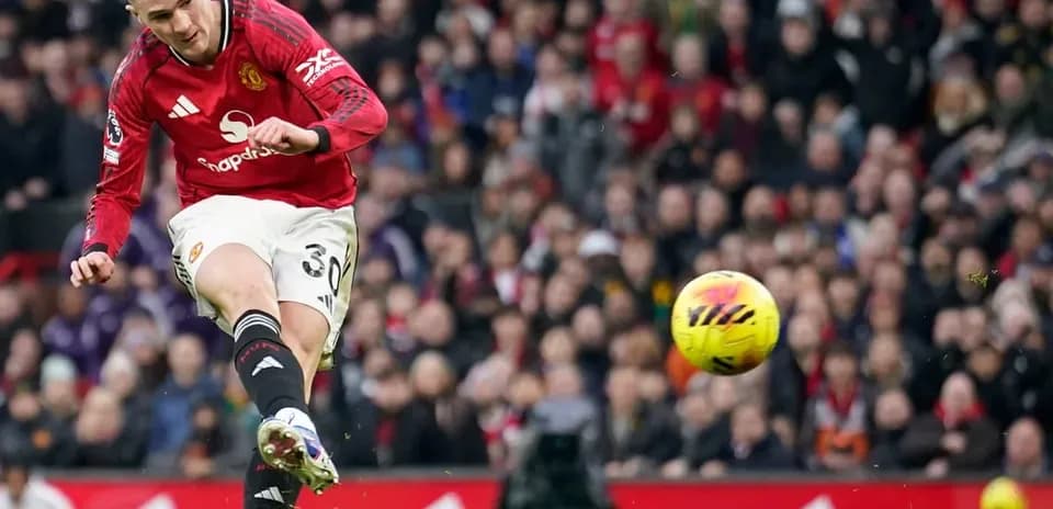 Manchester United player striking the ball