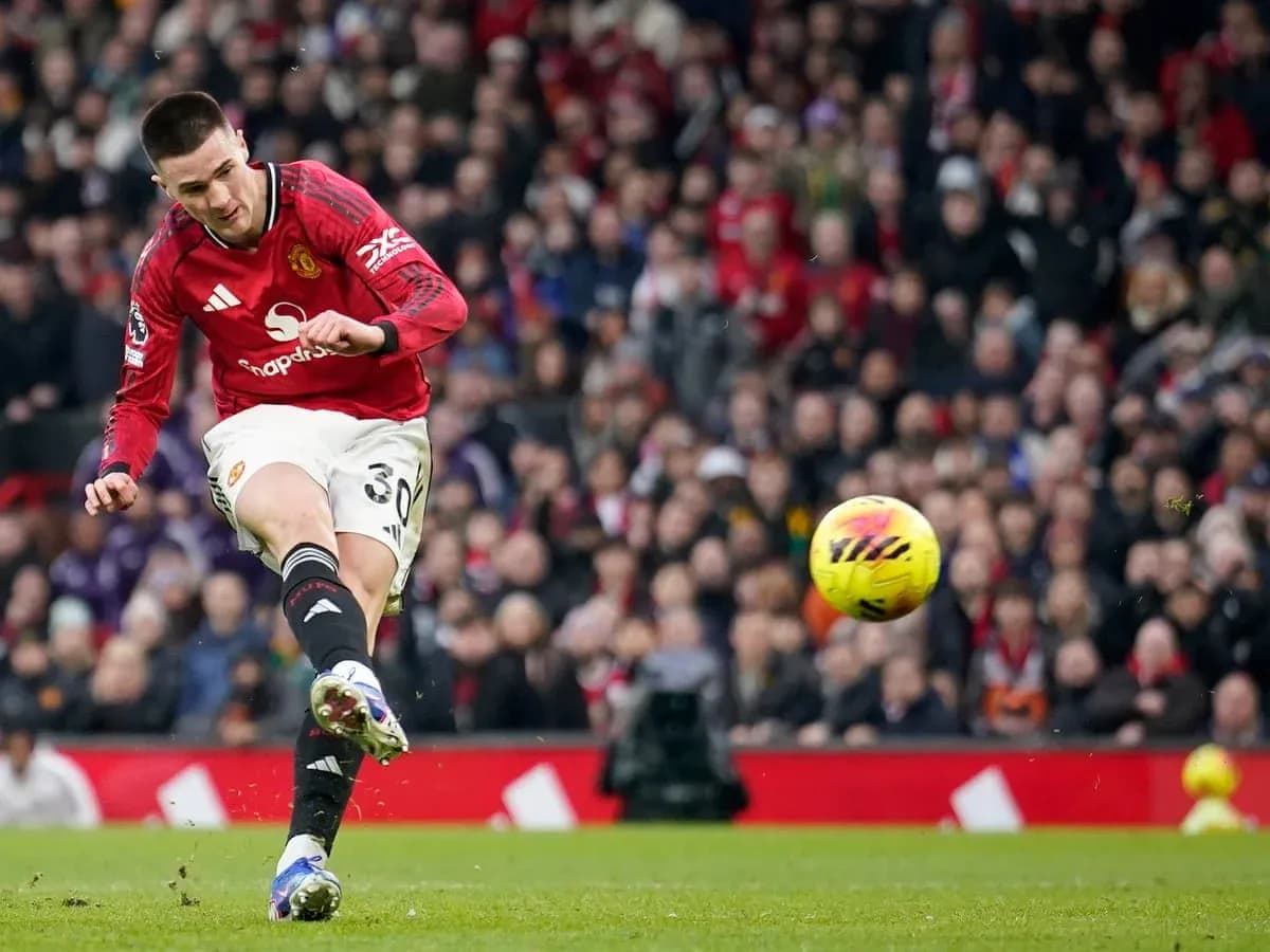 Manchester United player striking the ball