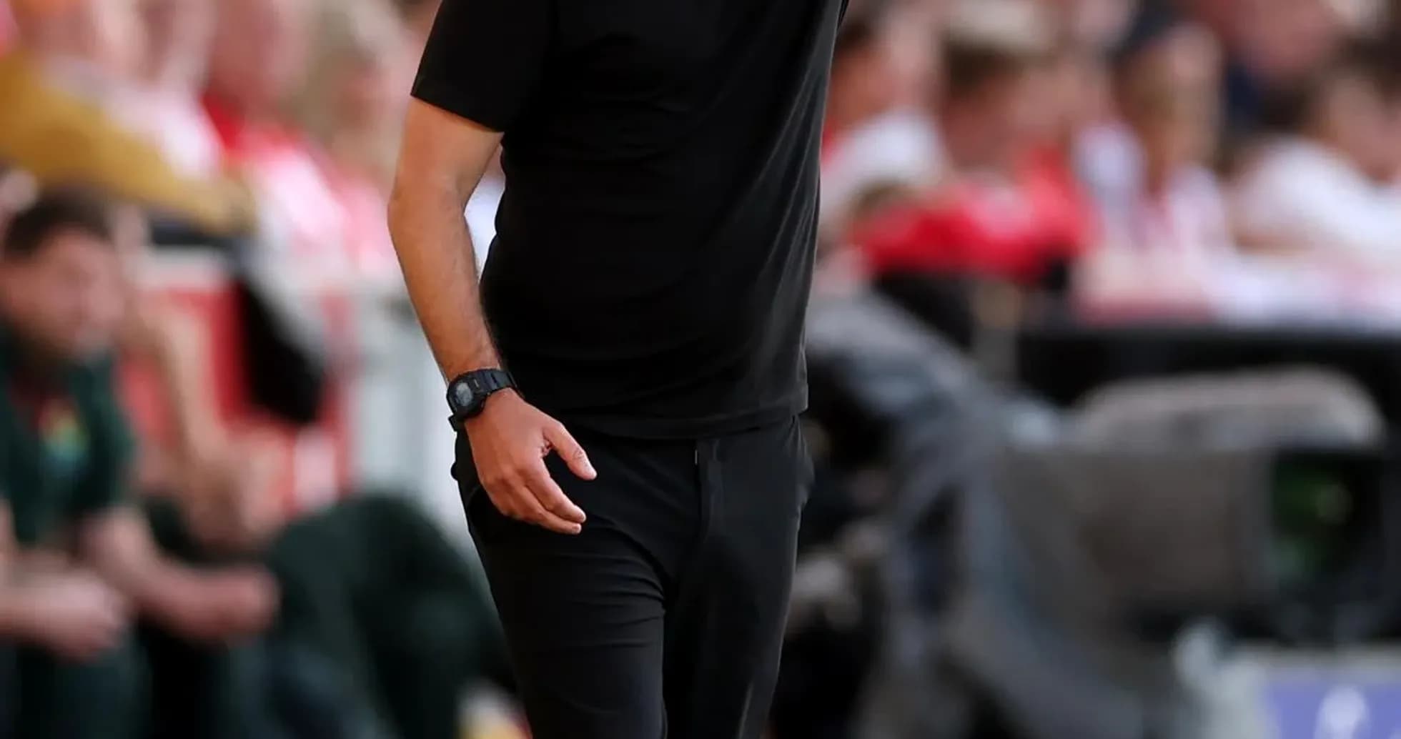 Coach directing players from the sidelines during match