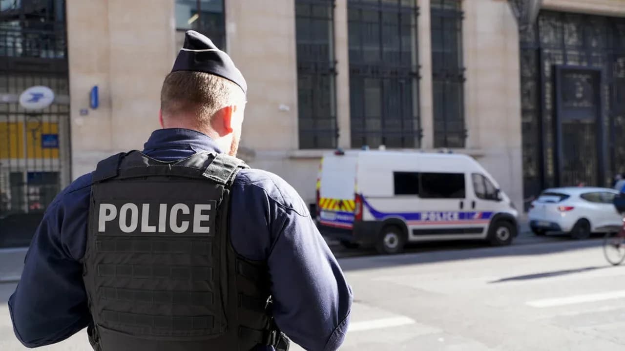 Police officer standing near police van on street