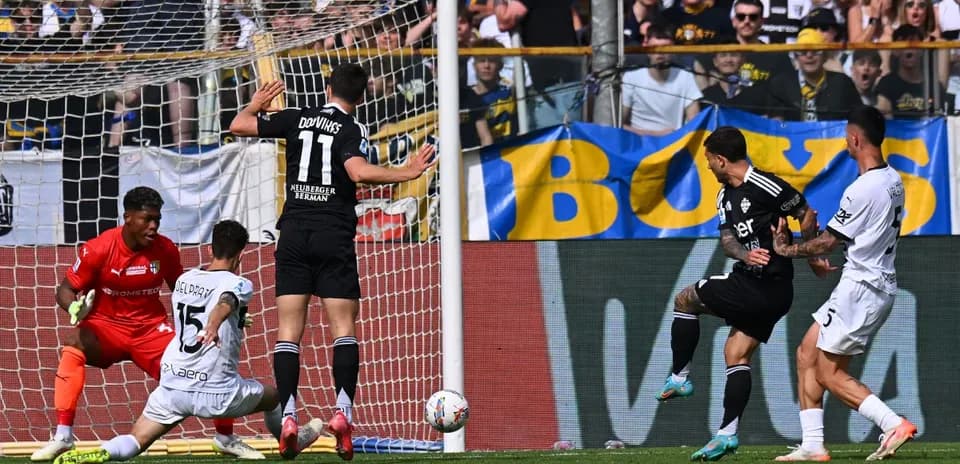 Como player shooting at goal during match