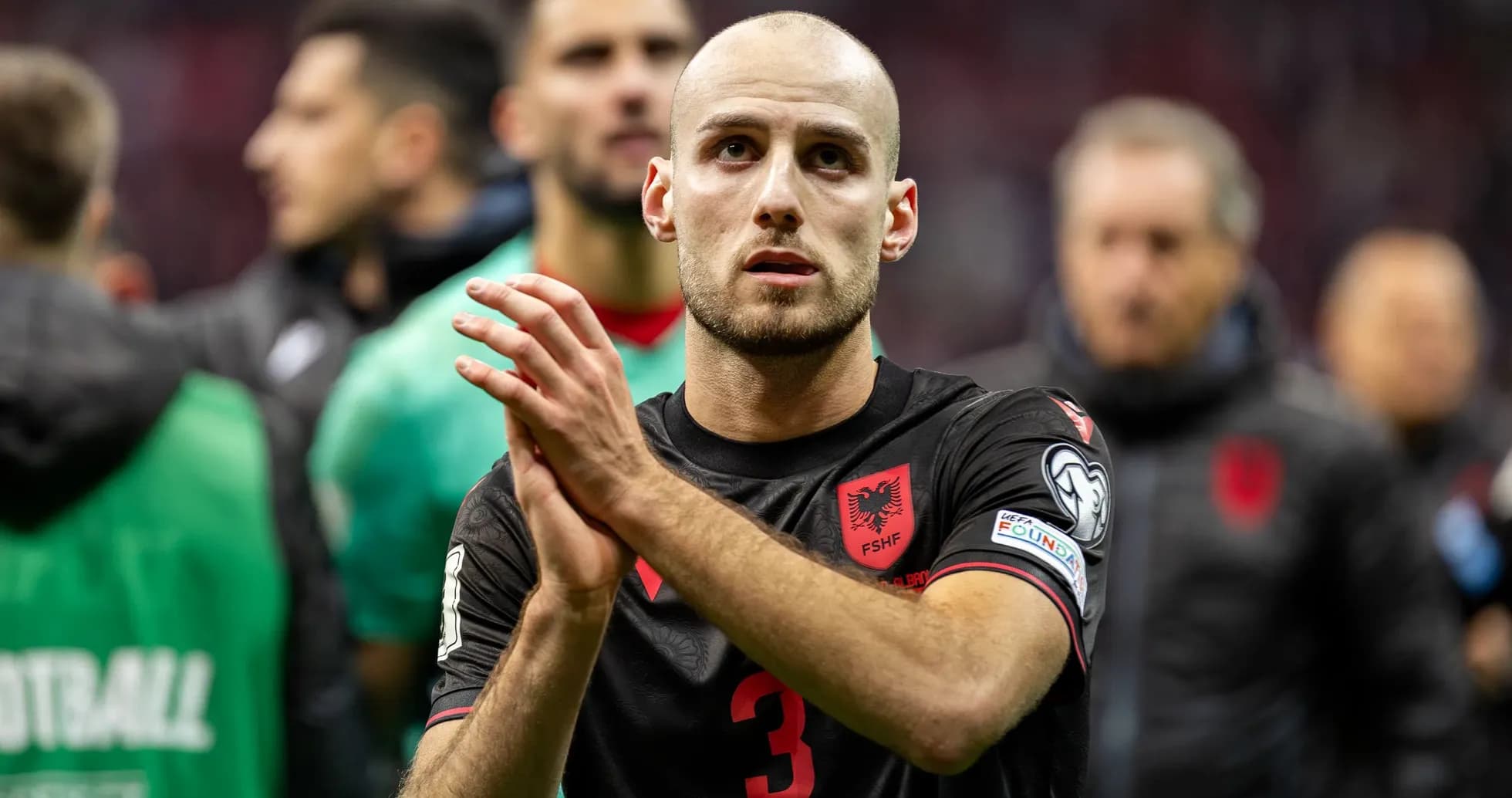 Albanian player applauding after the match