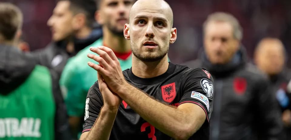 Albanian player applauding after the match