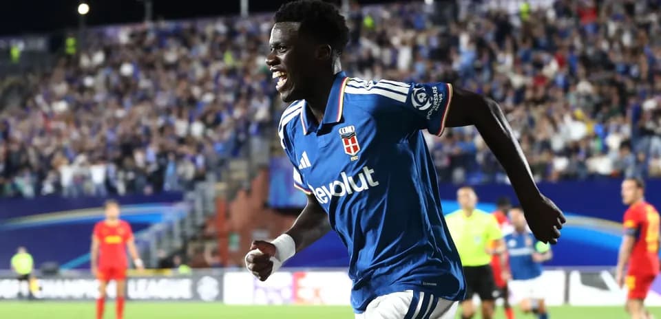 Player celebrating a goal in a crowded stadium