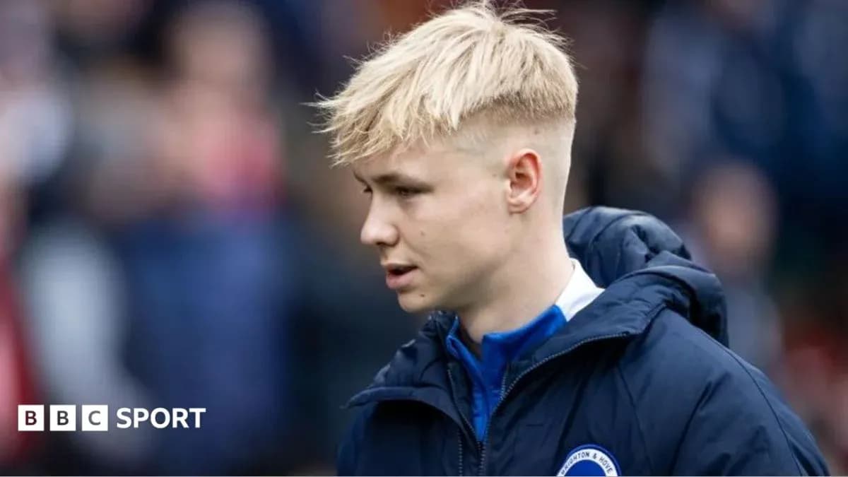 Player walking on the sidelines in team jacket
