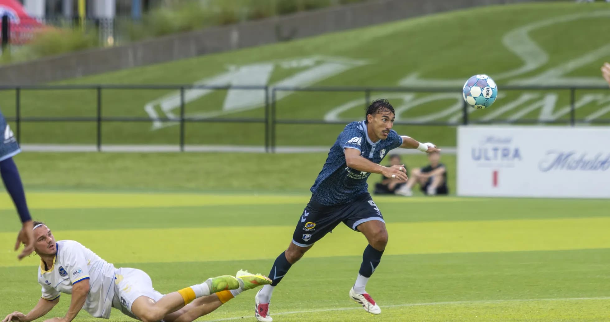 Player chasing ball during Naples vs Sarasota match