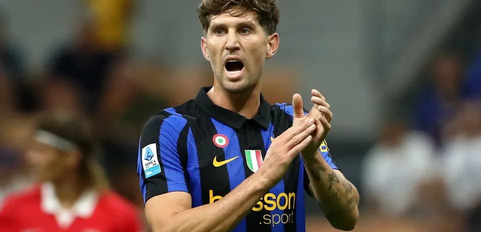 Player in blue and black jersey clapping during match