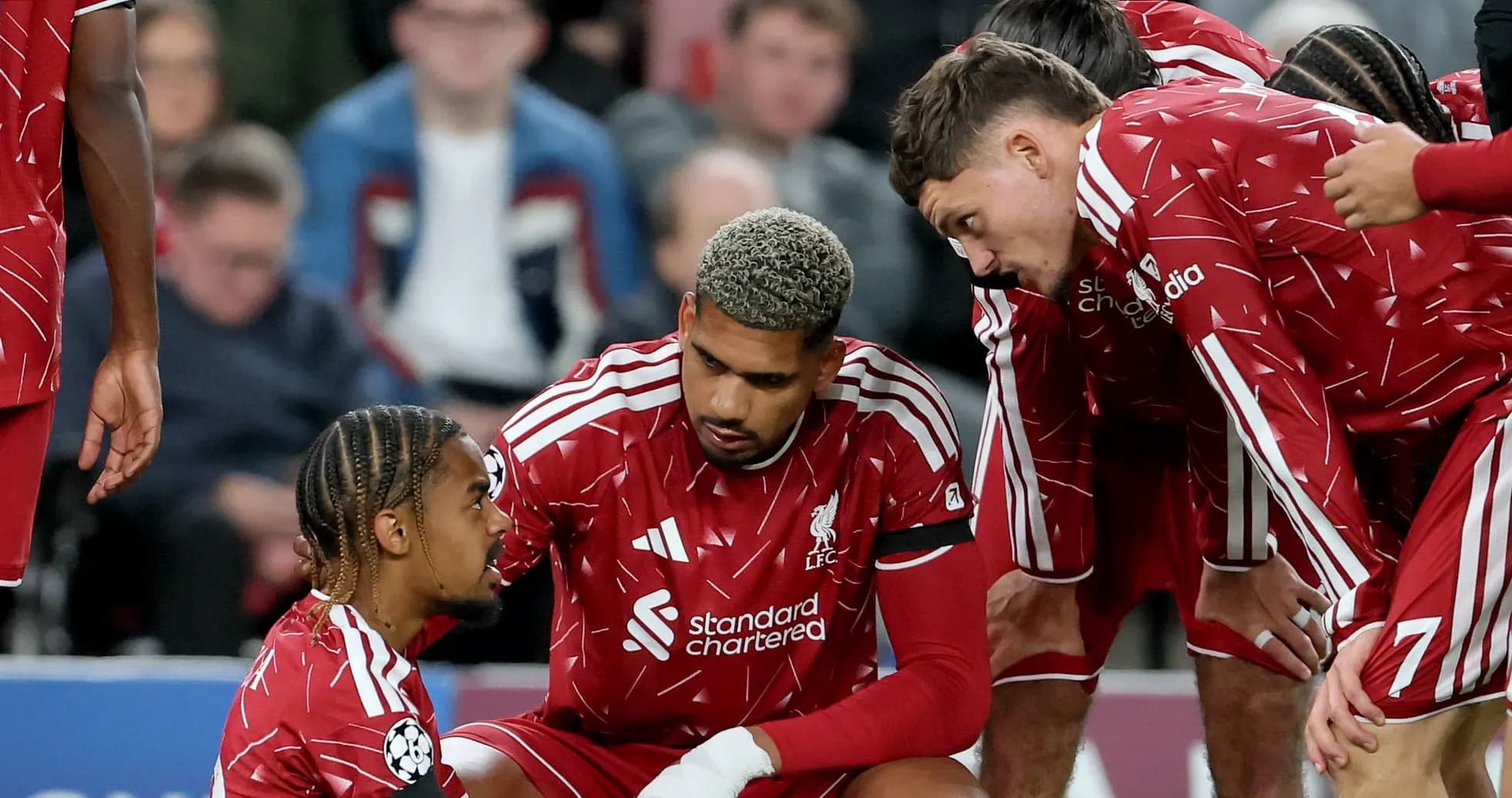 Liverpool players discussing strategy during match timeout