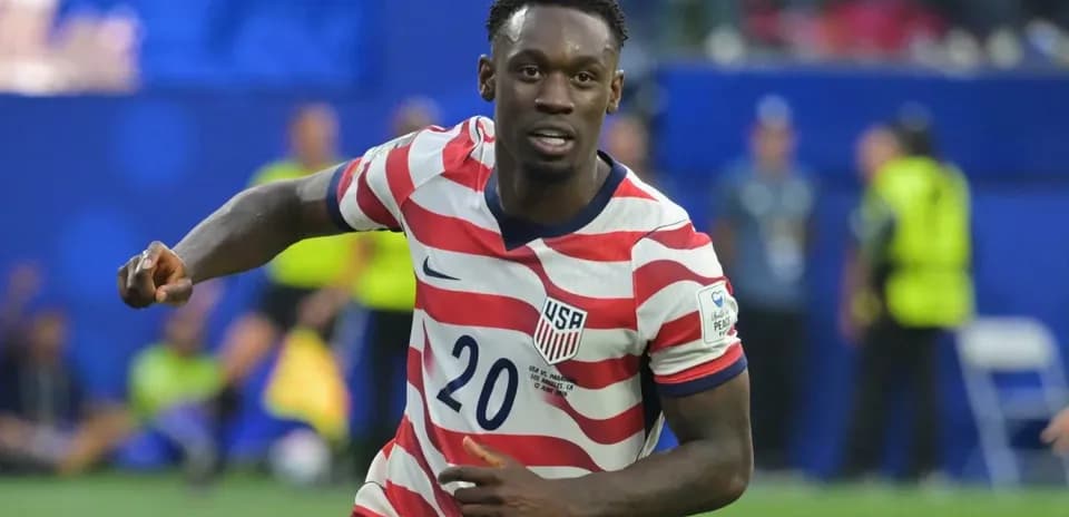 Player in red and white striped jersey celebrating