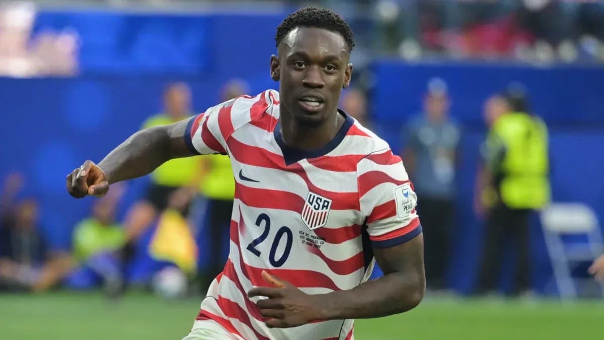 Player in red and white striped jersey celebrating