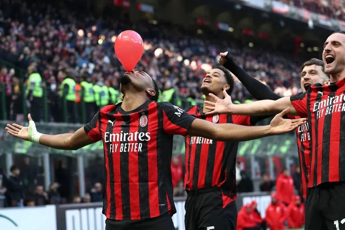 AC Milan players celebrating with a balloon during match