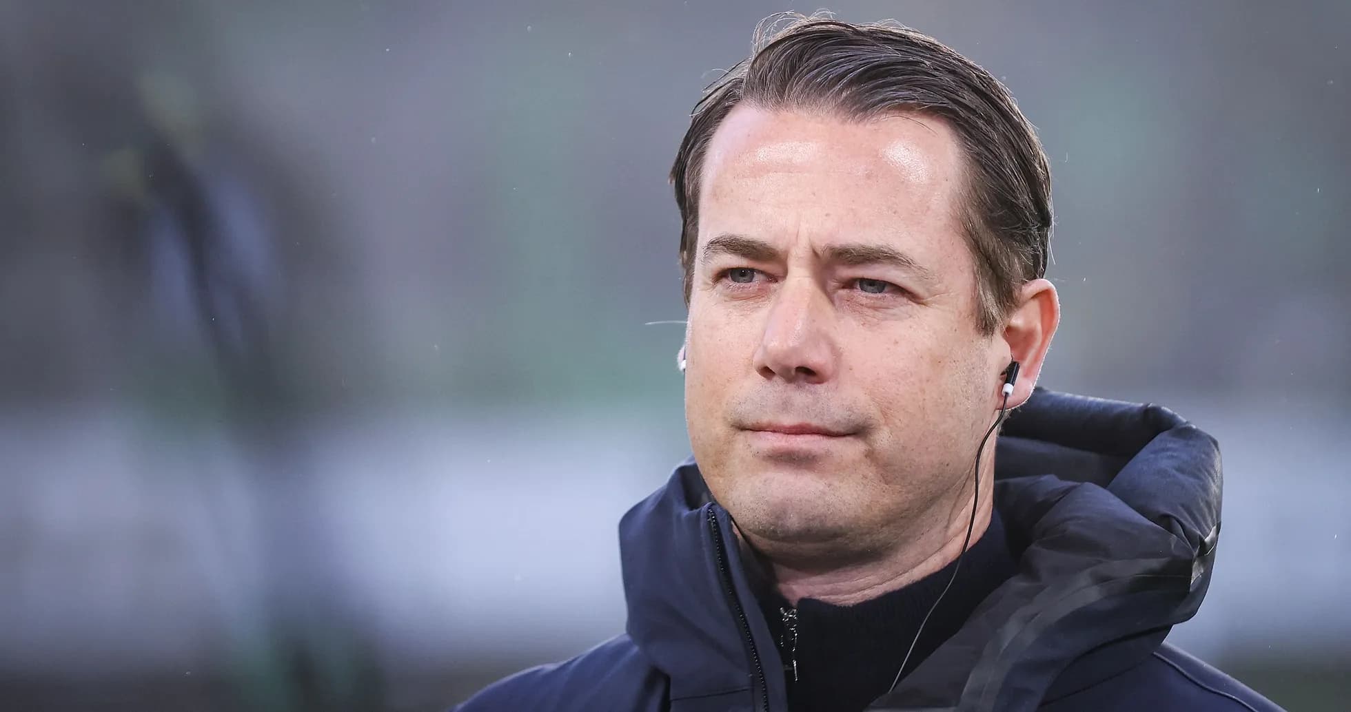 Coach wearing headphones during match preparation