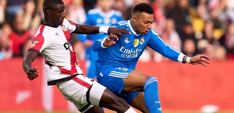 Player from Real Madrid being challenged by opponent